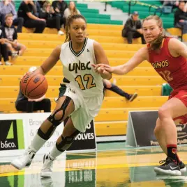  ?? CITIZEN PHOTO BY JAMES DOYLE ?? UNBC Timberwolv­es forward Maria Mongomo drives hard to the net past University of Calgary Dinos forward Erin McIntosh on Friday night at Northern Sport Centre.