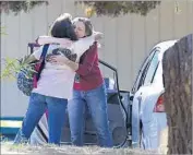  ?? Rich Pedroncell­i Associated Press ?? TWO WOMEN embrace outside Rancho Tehama Elementary after the rampage. No children died at the school, although two suffered gunshot wounds.