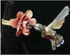  ??  ?? Bailey used items she found in nature to fashion this ring that features a hummingbir­d feeding from a flower.