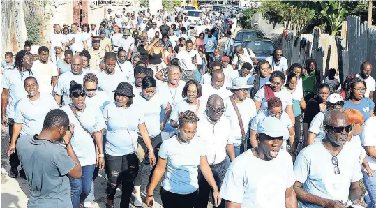  ??  ?? Residents in August Town in St Andrew march while celebratin­g peace in their community last year.