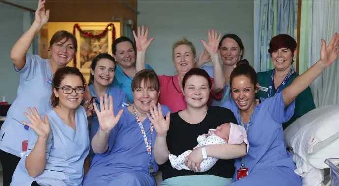  ??  ?? Michelle Montague, from Trim holds her baby Maeve, with maternity staff members, from left to right, Catherine Smith, Maria McNamee, Pamela McElroy, Denise Moore, Linda Flood, Mags O’Malley, Eunice Nolan, Jo Burns and Ciara Dunne, baby Maeve was born at 3 secs past midnight in our Lady of Lourdes hospital in Drogheda. Picture credit; Damien Eagers / INM