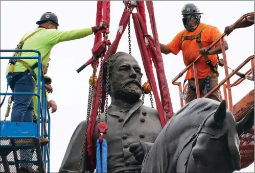  ?? (AP/Steve Helber) ?? Workers steady a crane lifting the statue of Lee on Monument Avenue on Wednesday.