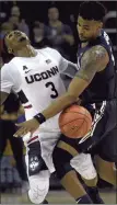  ?? BRAD HORRIGAN/HARTFORD COURANT ?? UConn guard Alterique Gilbert, left, collides with Xavier Musketeers forward Danny Ramsey on Friday in the Charleston Classic.