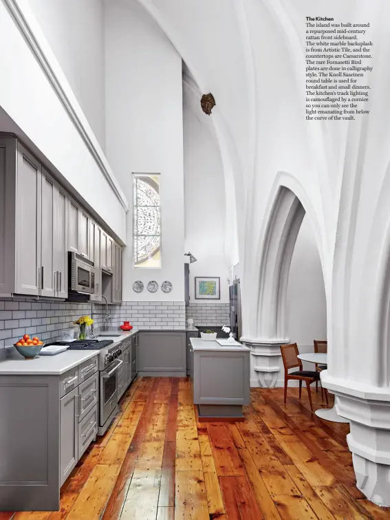  ??  ?? The Kitchen
The island was built around a repurposed mid-century rattan front sideboard.
The white marble backsplash is from Artistic Tile, and the countertop­s are Caesarston­e. The rare Fornasetti Bird plates are done in calligraph­y style. The Knoll Saarinen round table is used for breakfast and small dinners. The kitchen’s track lighting is camouflage­d by a cornice so you can only see the light emanating from below the curve of the vault.