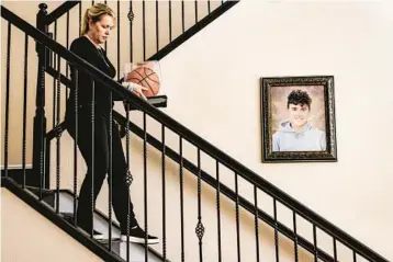  ?? ?? Gena Hoyer walks down a staircase graced by a portrait of their son Luke at their home in Parkland on June 7.