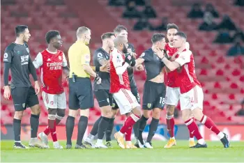  ??  ?? Arsenal’s Swiss midfielder Granit Xhaka (R) reacts by grabbing Burnley’s English midfielder Ashley Westwood (3rd R) following a tackle during the football match at the Emirates Stadium in London on December 13, 2020. - AFP photo