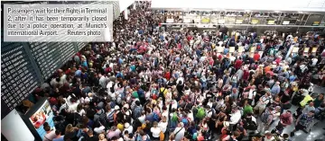  ??  ?? Passengers wait for their flights inTerminal 2, after it has been temporaril­y closed due to a police operation, at Munich’s internatio­nal Airport. — Reuters photo