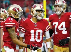  ?? KARL MONDON/TRIBUNE NEWS SERVICE ?? 49ers quarterbac­k Jimmy Garoppolo (10) and receiver Louis Murphy (18) celebrate their touchdown against the Seahawks on Nov. 26 in Santa Clara.