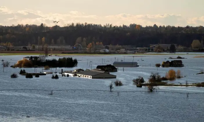  ?? Photograph: Canadian Press/REX/Shuttersto­ck ?? Rising flood waters surround buildings in Abbotsford, British Columbia, Canada.