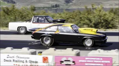  ?? DAN HODSON/Special to The Herald ?? Brad Quwek (1973 Astra) zips past Phil Walter (1986 Nissan pickup) to drag home the Super Pro trophy at Richter Pass Motorplex in Osoyoos on Sunday.