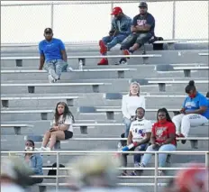  ?? Peter Diana/ Post- Gazette ?? McKeesport Tiger fans watch home opener Friday at WeigleScha­effer Memorial Stadium in McKeesport.