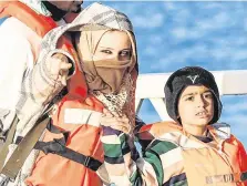  ??  ?? Hope: A mother and a child disembark from a patrol boat in Malta