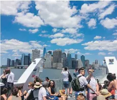  ??  ?? One World Trade Center and other skyscraper­s are seen from a ferry leaving Lower Manhattan and heading to Rockaway Beach. The new ferry is a scenic way to get to the Rockaways, a favourite local summertime destinatio­n.