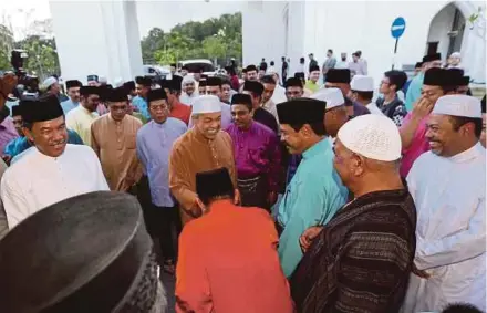  ?? HAQIM ROSMAN
PIC BY IQMAL ?? Deputy Prime Minister Datuk Seri Dr Ahmad Zahid Hamidi greeting Home Ministry staff and their families, as well as members of the public, during a ministry event at Masjid Hussain in Seremban yesterday. With him is Negri Sembilan Menteri Besar Datuk...