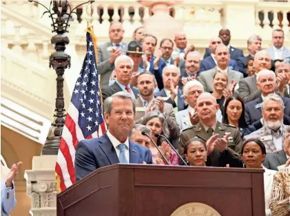  ?? MAYA HOMAN/SAVANNAH MORNING NEWS ?? Georgia Gov. Brian Kemp signed the FY 2025 budget into law on Tuesday at a ceremony in Atlanta.