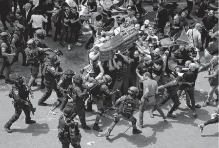  ?? Maya Levin /Associated Press ?? Israeli police confront mourners as they carry the casket of Al Jazeera journalist Shireen Abu Akleh during her funeral Friday in east Jerusalem. Abu Akleh, a Palestinia­n-american reporter, was shot dead during an Israeli military raid in the West Bank.