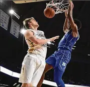  ?? MIKE COMER / GETTY IMAGES ?? Tech center Ben Lammers (left), being dunked on by Duke’s Wendell Carter Jr., has never fully recovered from a sprained ankle.