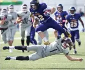  ?? MATHEW MCCARTHY, WATERLOO REGION RECORD ?? Wilfrid Laurier receiver Carson Oullette jumps over a tackle attempts by McMaster’s Adam Preocanin in the Golden Hawks’ 40-15 win Saturday.