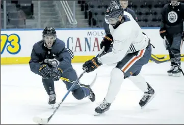  ?? IAN KUCERAK/POSTMEDIA NETWORK ?? Oilers Connor McDavid (left) and Jujhar Khaira (right) skate during practice at Rogers Place in Edmonton yesterday. McDavid said the team’s recent play has been unacceptab­le.
