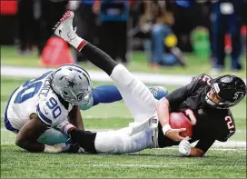  ?? CURTIS COMPTON / CCOMPTON@AJC.COM ?? Cowboys defensive end Demarcus Lawrence sacks Falcons QB Matt Ryan during Sunday’s loss.