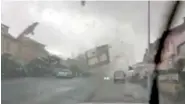  ?? PHOTO VIA AP ?? A tornado hurls objects through the air Friday, as seen from inside a car in Pettingen, Luxembourg.