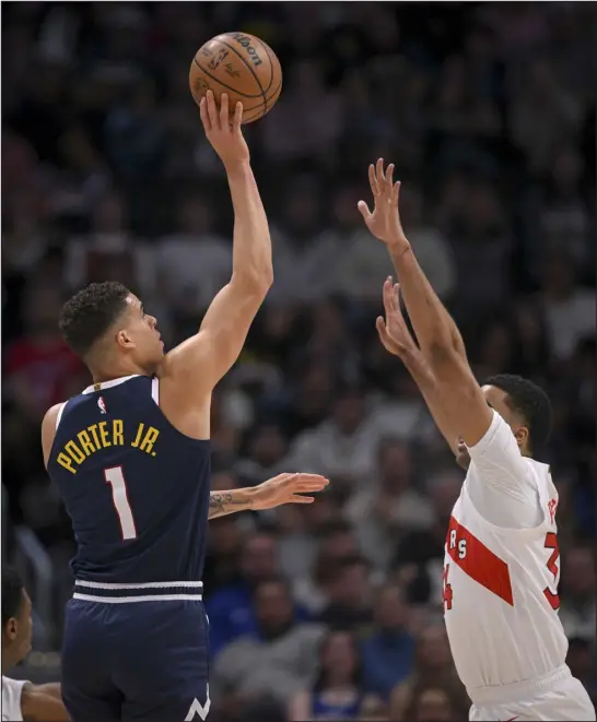  ?? AARON ONTIVEROZ — THE DENVER POST ?? Michael Porter Jr. (1) of the Denver Nuggets shoots over Jontay Porter (34) of the Toronto Raptors during the first quarter at Ball Arena in Denver on Monday.