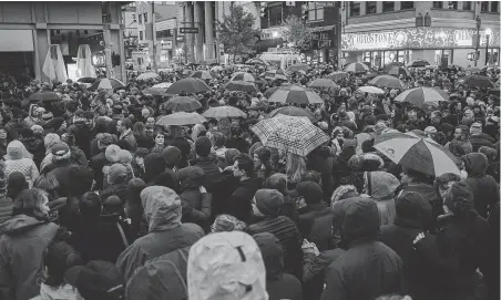  ??  ?? People gather Saturday for an interfaith candleligh­t vigil a few blocks away from the site of a mass shooting at the Tree of Life Synagogue in Pittsburgh. Hundreds mourned the dead and pray for the wounded at three separate such events in the area. Jeff Swensen / Getty Images