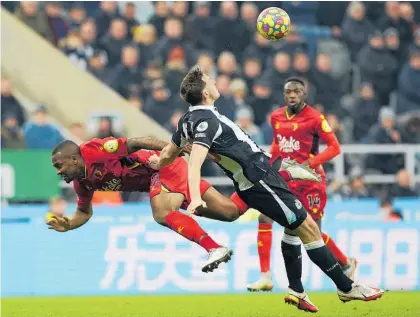  ?? Photo / AP ?? Chris Wood, right, in his first game for Newcastle United, tangles with Watford’s Samir.