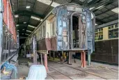  ?? ?? Above: The body of No. 3299 stands in the carriage shed jacking area on May 12, with the underframe and bogies removed and the bottom rail or the body supported on wooden beams.