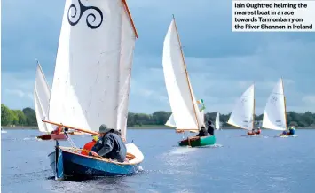  ?? ?? Iain Oughtred helming the nearest boat in a race towards Tarmonbarr­y on the River Shannon in Ireland