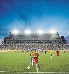  ?? ?? Canada’s Mo Babouli battles against Brazil’s Luciano Da Rocha during men’s soccer action at the CIBC Hamilton Pan Am Soccer Stadium (Tim Hortons Field) in Hamilton on July 12, 2015.