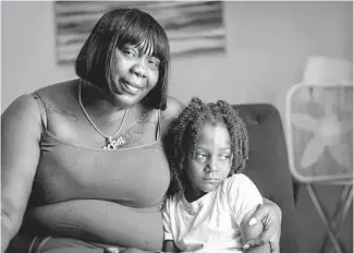  ?? BRIAN CASSELLA/CHICAGO TRIBUNE ?? LaSheena Weekly with her grandson, Carlton Weekly Jr., 5, at her home June 17. Weekly lost her son Carlton Weekly, who rapped under the name FBG Duck, to gun violence last year. Earlier, she’d lost her son Jermaine Robinson, known as rapper FBG Brick, in 2017.