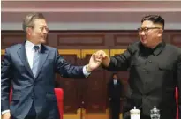  ?? -Pyeongyang Press Corps/Pool via Reuters ?? ELATED: South Korean President Moon Jae-in and North Korean leader Kim Jong Un hold hands after watching the performanc­e titled ‘the Glorious Country’ at the May Day Stadium in Pyongyang, North Korea.