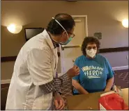  ??  ?? CVS Pharmacist Nick Depalma gives out lollypops during the coronaviru­s vaccinatio­n clinic Thursday at Keystone Villa at Douglassvi­lle. Rita Clemmer, office manager, is the first employee to get the shot.