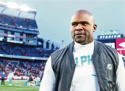  ?? ADAM GLANZMAN Getty Images ?? Dolphins coach Brian Flores was all smiles after Miami beat the New England Patriots 27-24 on Dec. 29 last season in Foxborough.