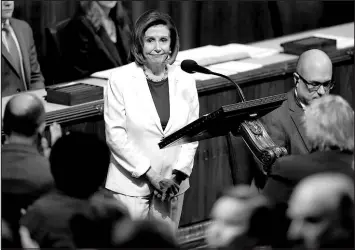  ?? CAROLYN KASTER / ASSOCIATED PRESS ?? Lawmakers stand and applaud as House Speaker Nancy Pelosi pauses during a speech on the House floor Nov. 17.