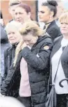  ??  ?? Patricia with family members at Stephen’s funeral, and (top) a candle in memory of her son