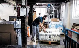  ?? ALEX ATACK/THE NEW YORK TIMES ?? Bags of flour are loaded onto a pallet May 15 at Wessex Mill in Wantage, England.