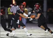  ?? TIM PHILLIS — FOR THE NEWS-HERALD ?? Alex Henry hands off to Sean Carr during Chardon’s Division III state semifinal against West Holmes.