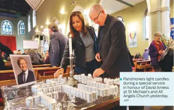  ?? AFP ?? Parishione­rs light candles during a special service in honour of David Amess at St Michael’s and All Angels Church yesterday.