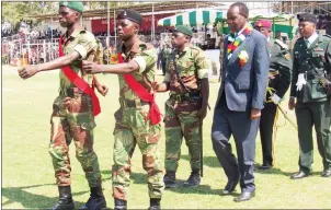  ??  ?? Minister of State for Masvingo Provincial Affairs Senator Josaya Hungwe inspects a Guard of Honour during Zimbabwe Defence Forces Day celebratio­ns at Mucheke Stadium in Masvingo yesterday.