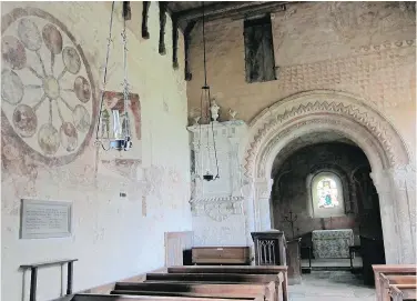  ??  ?? The interior of St. Mary’s Church. On the left of the photo is a depiction of the Wheel of Life. Experts believe the earliest of the church’s paintings date from around 1130 AD though the Wheel of Life is believed to be from the 14th or 15th century.