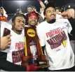  ?? EMIL LIPPE — THE ASSOCIATED PRESS ?? Ferris State players pose for photos with the Division II l championsh­ip trophy after defeating Valdosta State in Saturday’s national title game.