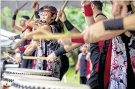  ??  ?? Yukako Beatty plays a bamboo Japanese flflute known as a fue alongside other members of the Fushu Daiko drummers. Many attendees at this year’s Oshogatsu at the Morikami named the taiko drumming as a favorite feature of the festivitie­s