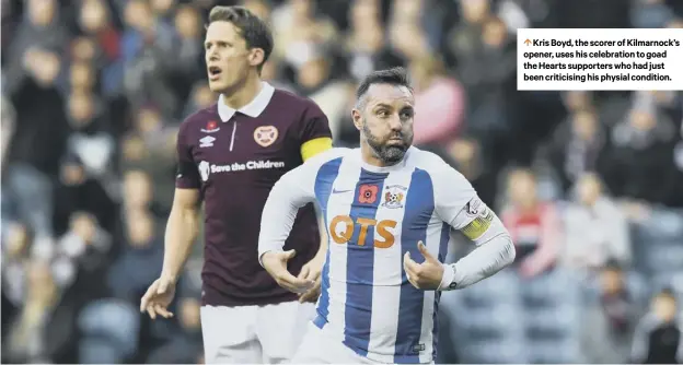  ??  ?? 0 Kris Boyd, the scorer of Kilmarnock’s opener, uses his celebratio­n to goad the Hearts supporters who had just been criticisin­g his physial condition.