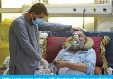  ?? AFP ?? KABUL: A family member comforts a COVID-19 patient at the intensive care unit (ICU) of the Muhammed Ali Jinnah hospital in Kabul. —