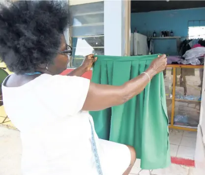  ??  ?? Maureen Pinto from Bedward Gardens near August Town in St Andrew, makes school uniforms but has seen tough times since schools were closed to face-to-face learning due to COVID-19.