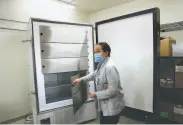  ?? Yalonda M. James / The Chronicle ?? Clinical pharmacist Leigh Witherspoo­n opens Santa Rosa Memorial Hospital’s ultracold freezer, which can hold 250,000 doses of the vaccine.