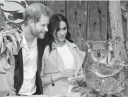  ?? Dean Lewins / Associated Press ?? Prince Harry and Meghan, the Duchess of Sussex, meet Ruby, a mother koala at Sydney’s Taronga Zoo.