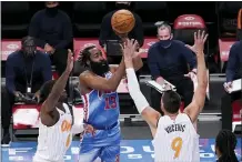  ?? MARY ALTAFFER — THE ASSOCIATED PRESS ?? Brooklyn’s James Harden, center, shoots past Orlando’s Dwayne Bacon, left, and Nikola Vucevic, right, on Saturday in New York.